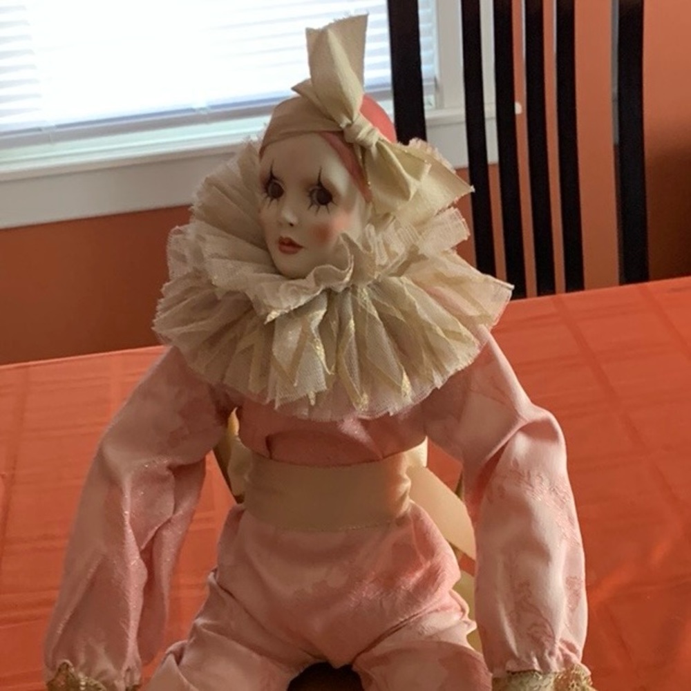 Accent porcelain doll sitting in a gold chair face hand an feet are porcelain